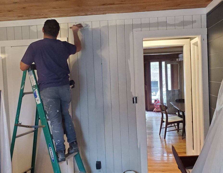 Andrys employee painting an office
